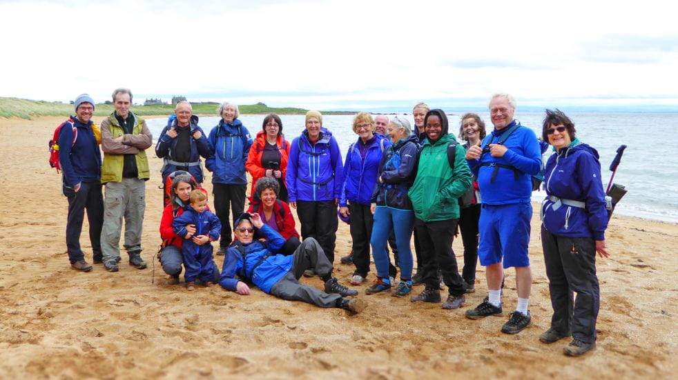 Ramblers pose on a beach walk in Fife. Credit: Ben Dolphin